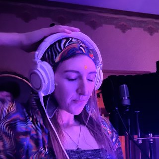 Julia Blake in the studio wearing headphones